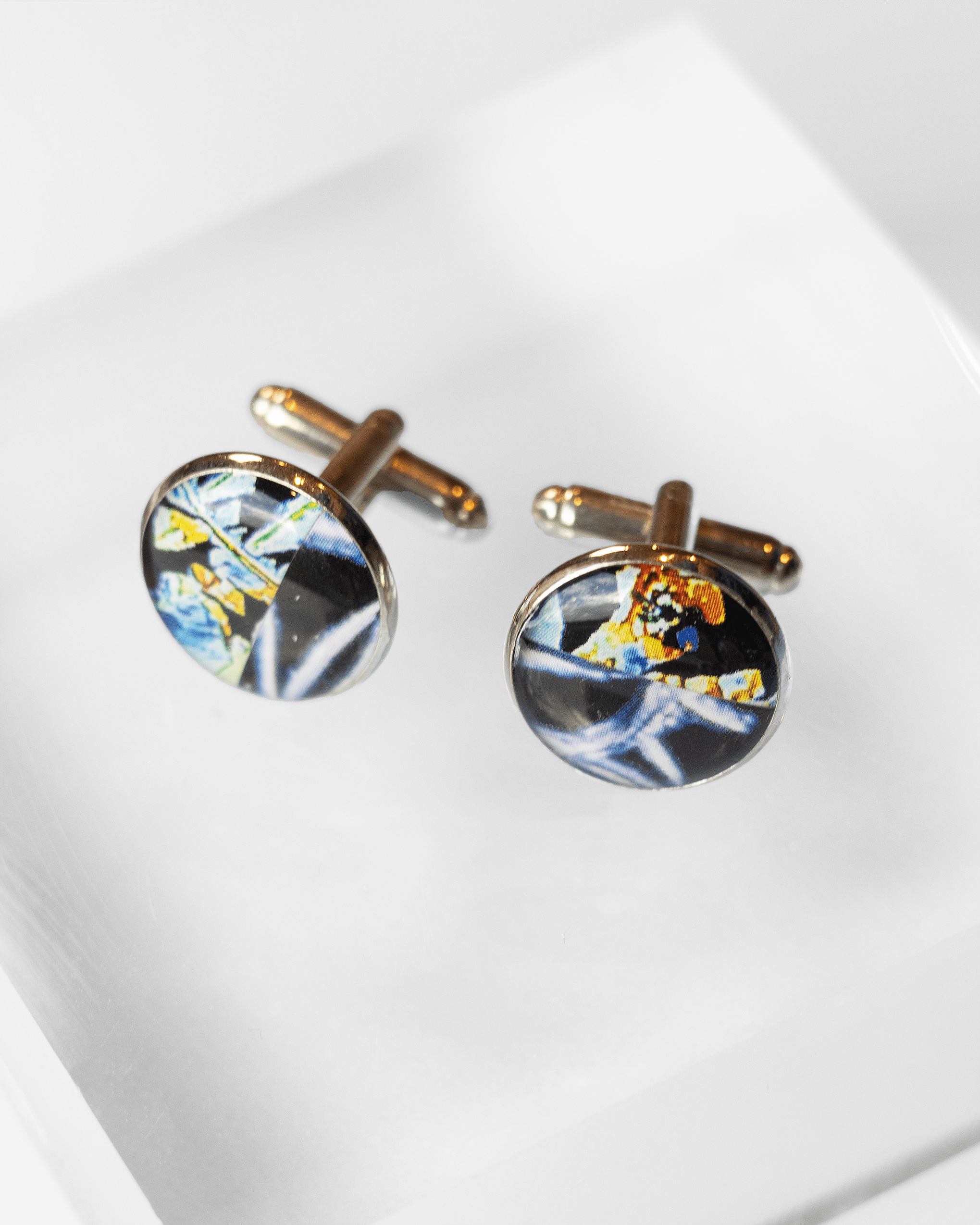 Handmade estrogen and testosterone microscopy cufflinks in resin and silver-plated brass — unique science jewelry symbolizing balance and identity. Above shot.