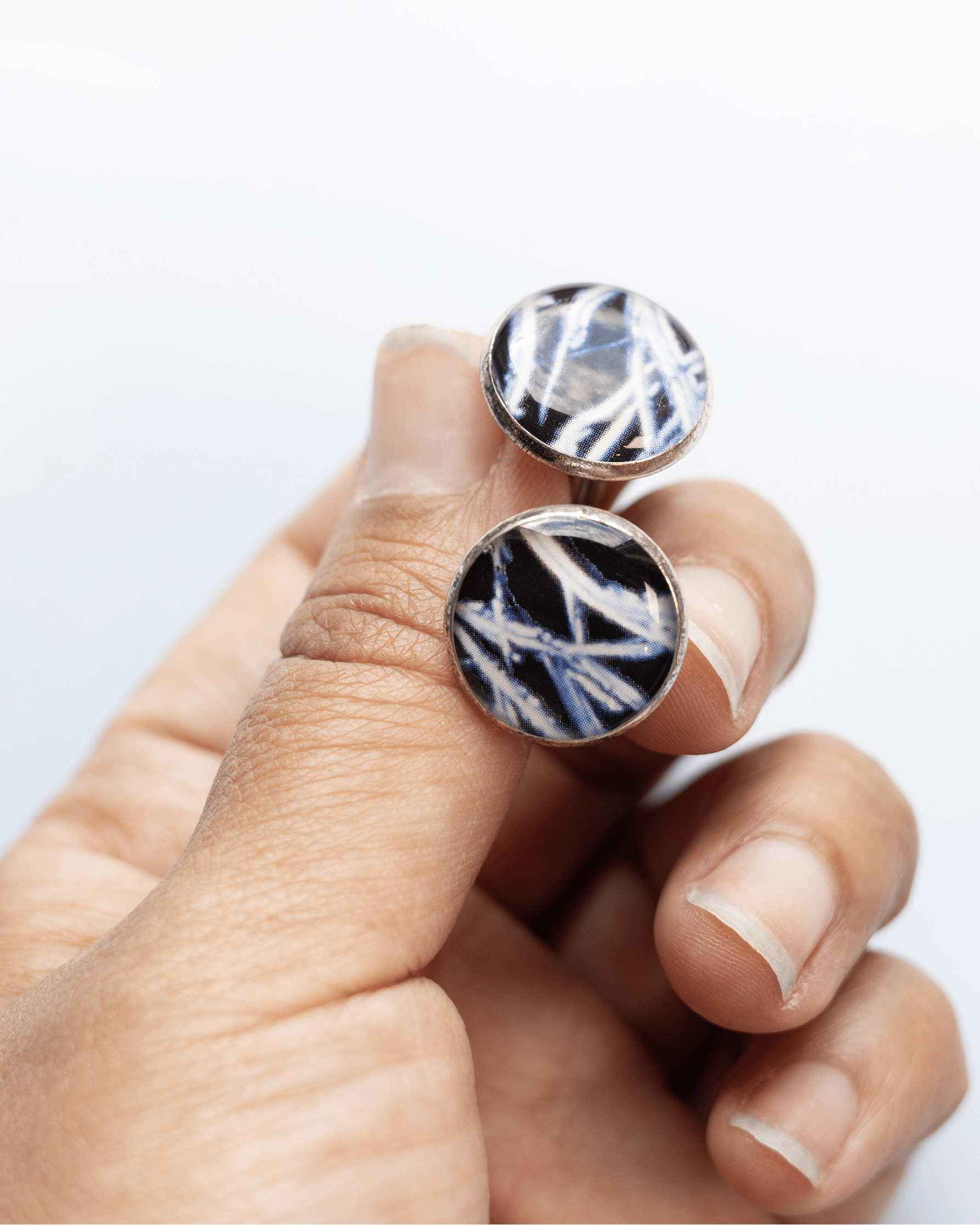 Handcrafted testosterone molecule microscopy cufflinks in silver-plated brass with resin finish. Bold science jewelry gift for people in STEM. Lifestyle image.