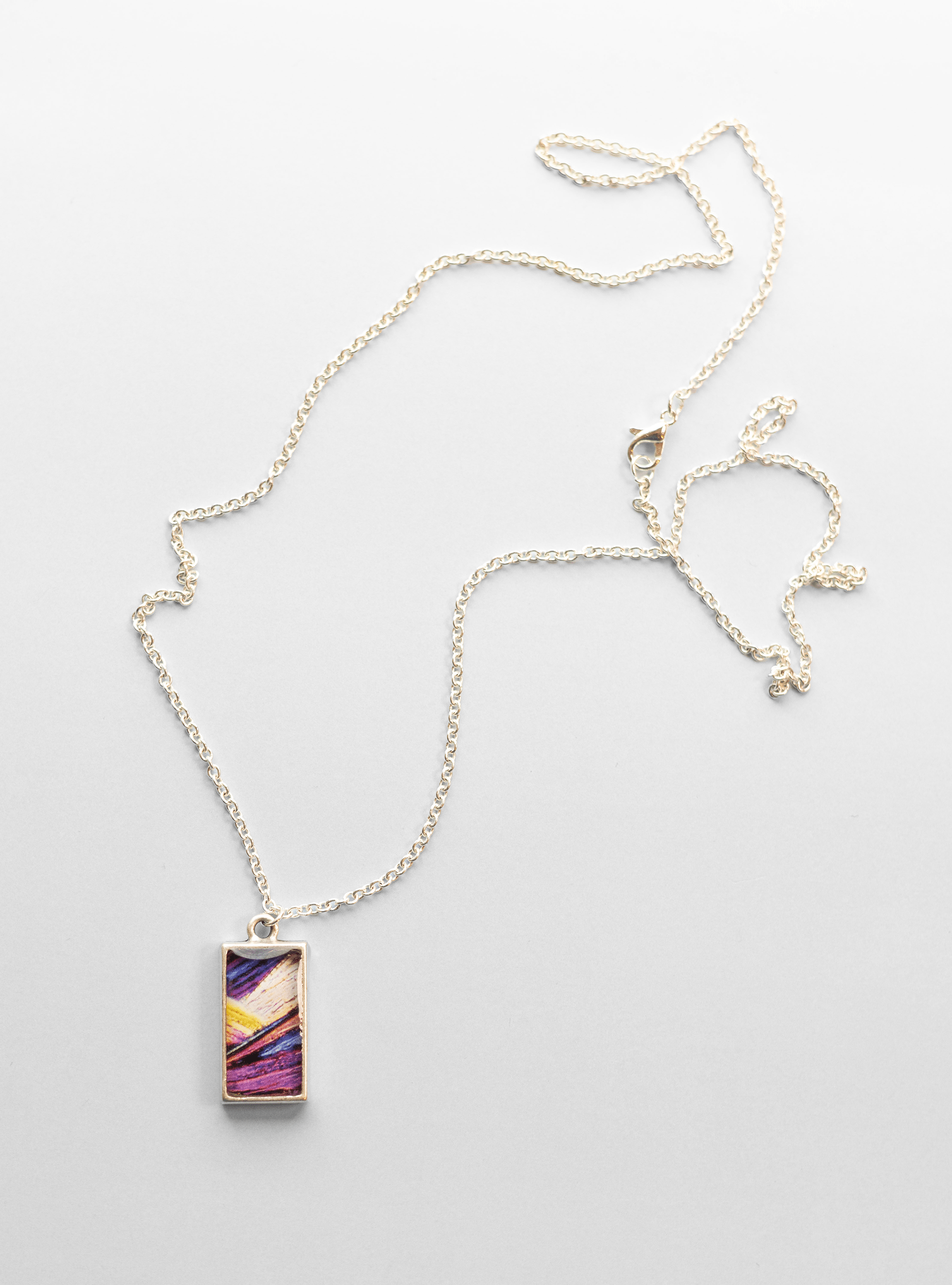 Arresting Necklace - Quantum Sunshine. Handmade jewelry featuring vivid microscopy sealed in resin. Science-inspired wearable art and meaningful science gift for doctors and STEM professionals. Full.