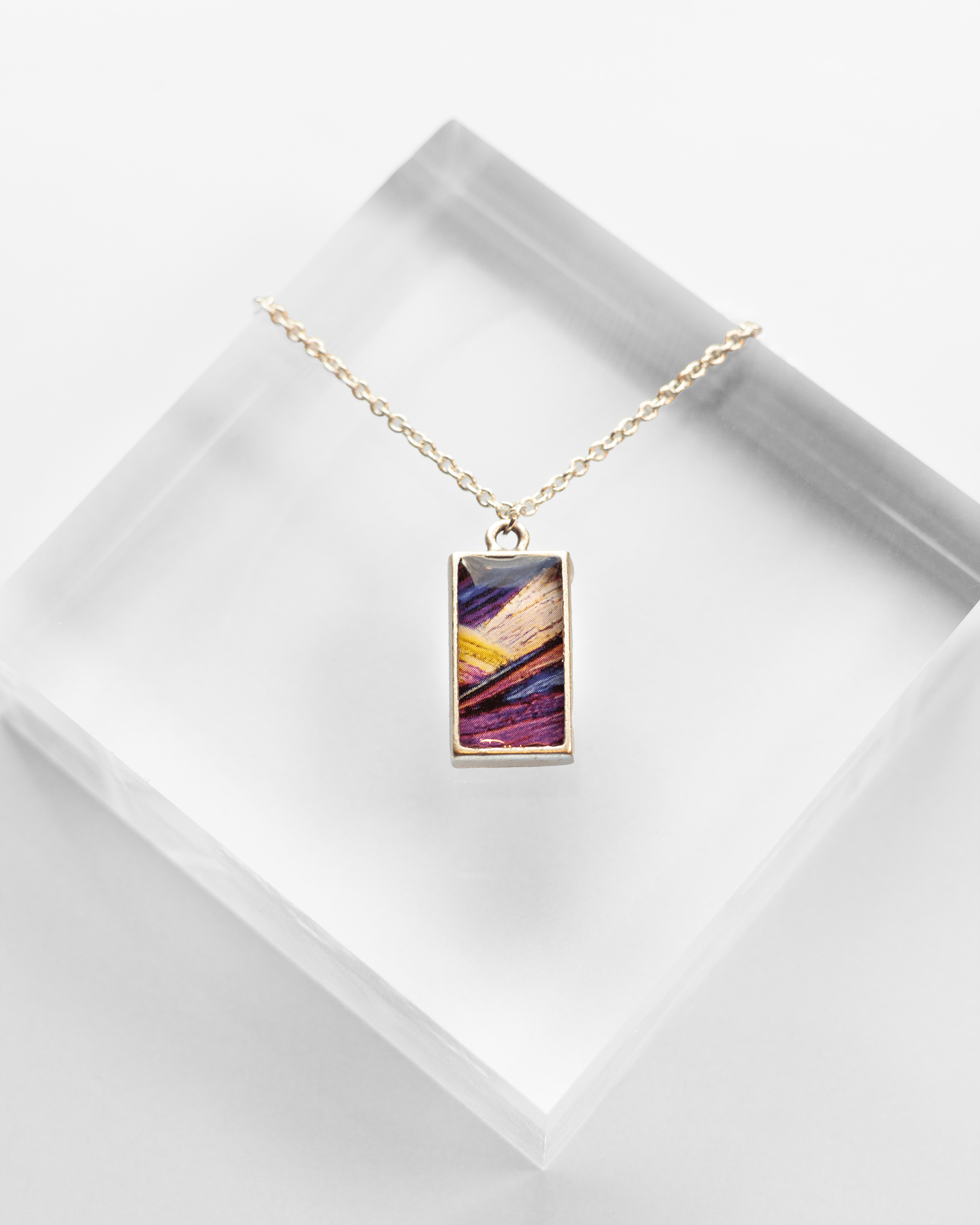 Arresting Necklace - Quantum Sunshine. Handmade jewelry featuring vivid microscopy sealed in resin. Science-inspired wearable art and meaningful science gift for doctors and STEM professionals.