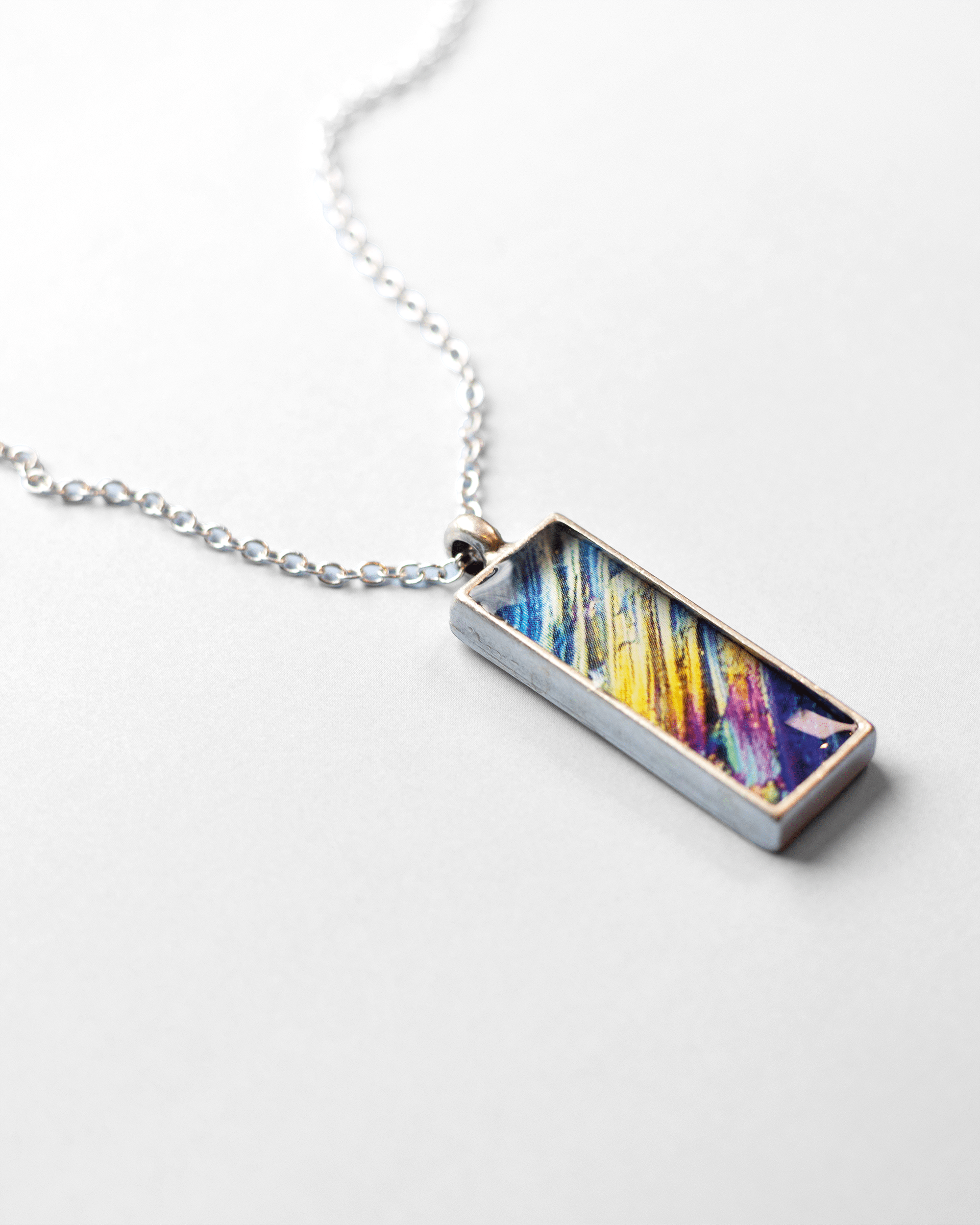 Rush Necklace - Quantum Sunshine. Handmade jewelry featuring vivid microscopy sealed in resin. Science-inspired wearable art and meaningful science gift for doctors and STEM professionals. Up close.