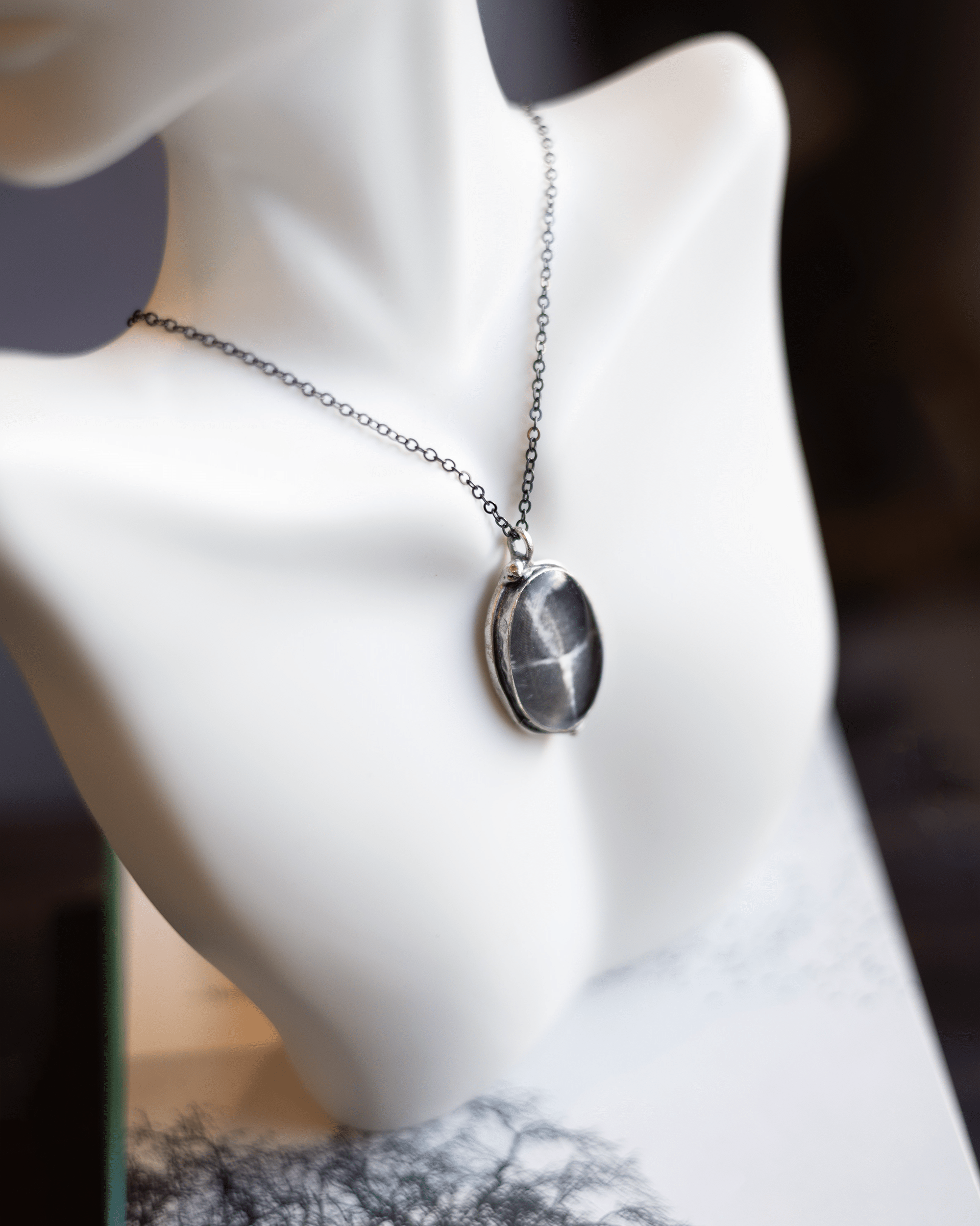 Unique ultrasound anatomy necklace handmade in resin and silver. Science art jewelry reflecting resonance and the beauty of sound. On bust.