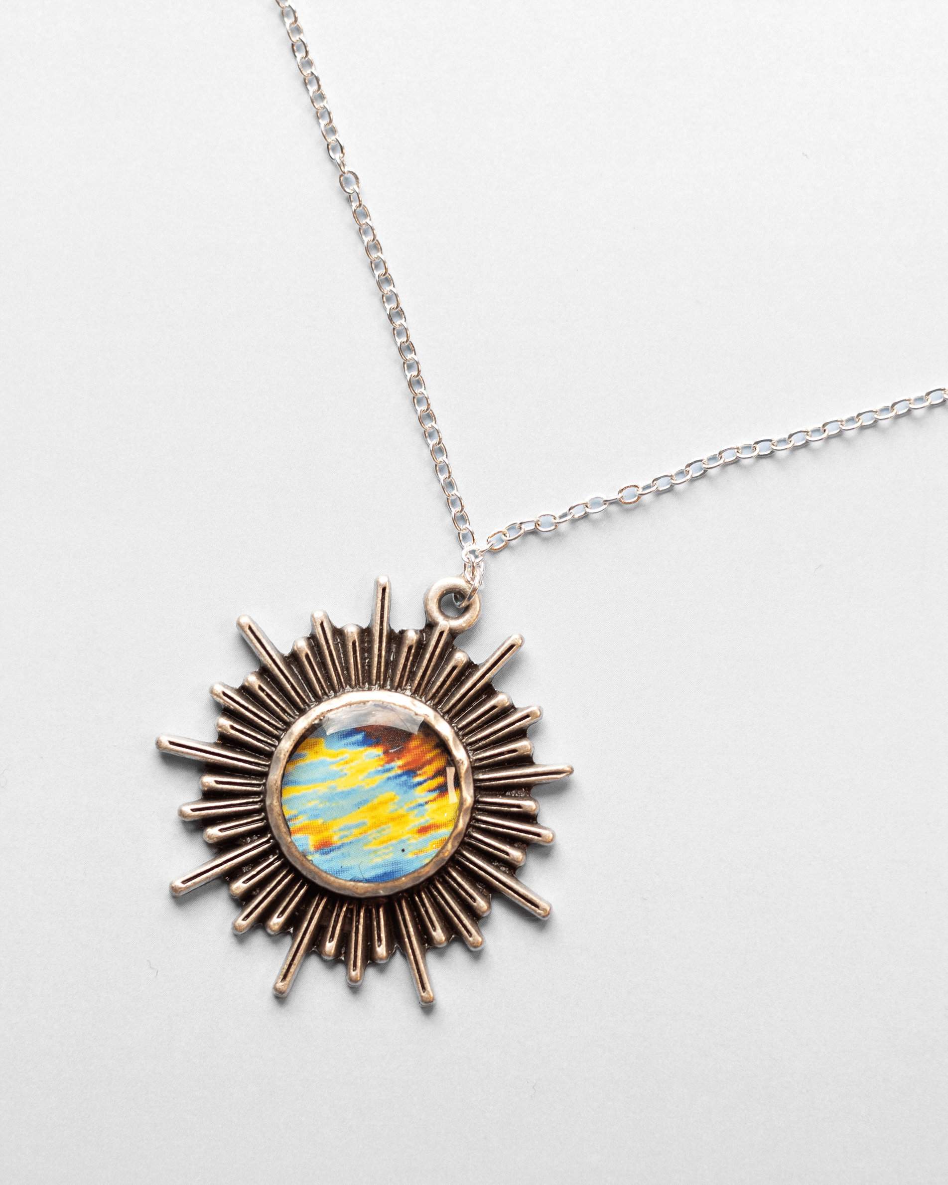 Handmade ultrasound heart necklace featuring real heart imagery. Vibrant sun shaped anatomical science jewelry gift for women in STEM and medicine. Up close, option B.