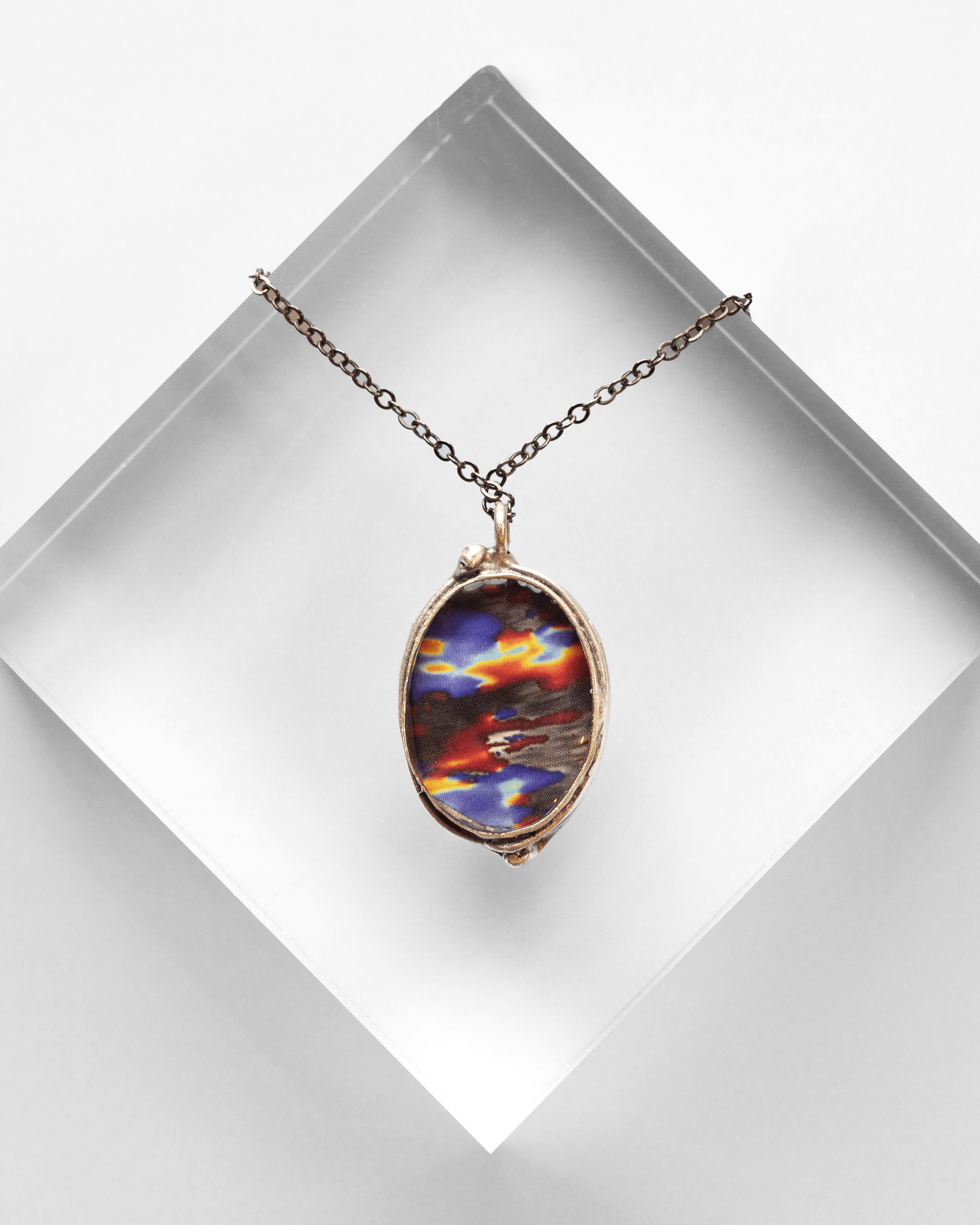 Ultrasound heart necklace handmade in resin and gold-tone finish. Colorful and elegant science jewelry celebrating love, anatomy, and art. Up close. Option B