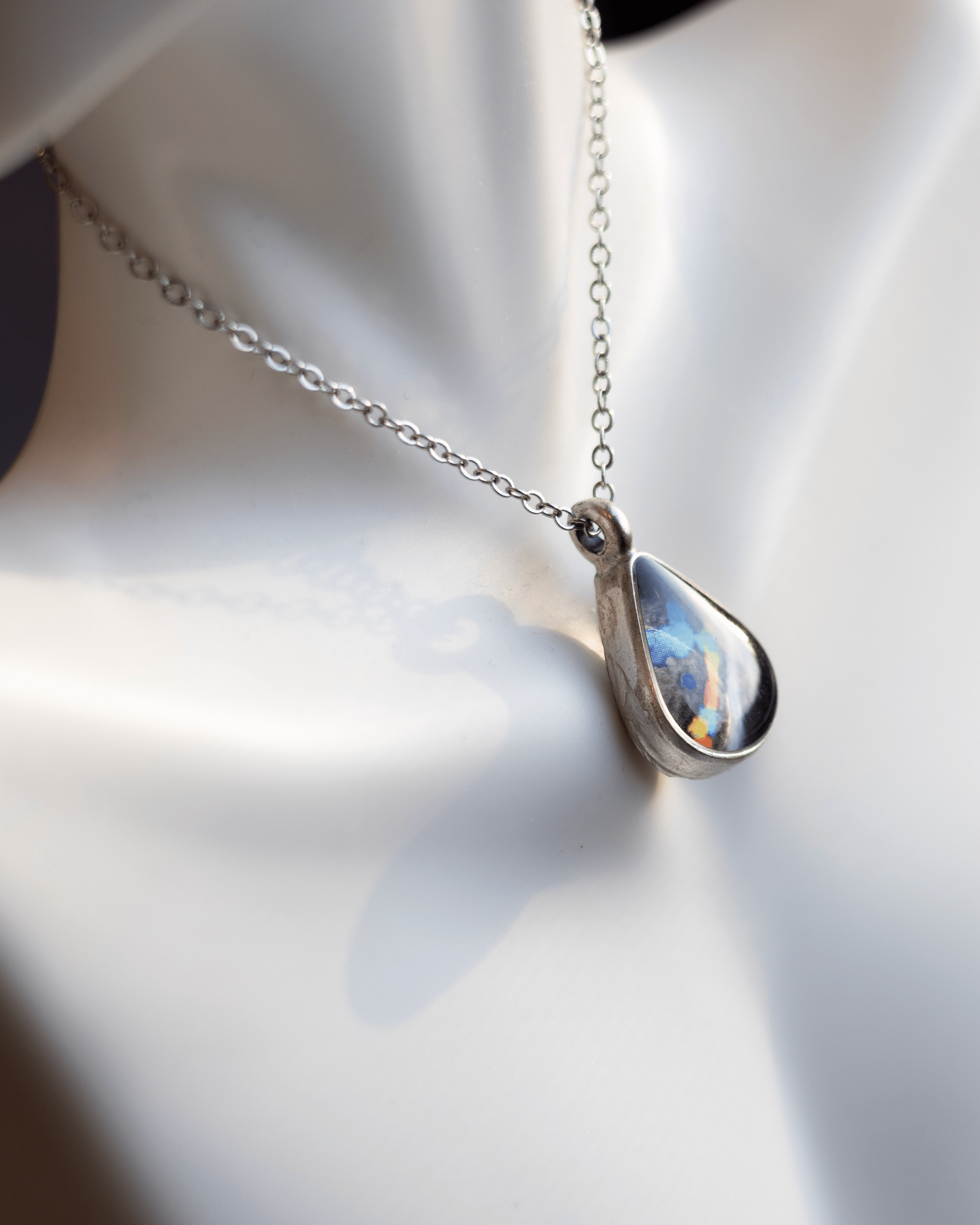 Heartbeat Necklace – Ultrasound Jewelry - Quantum Sunshine. Handmade jewelry featuring vivid ultrasound sealed in resin. Science-inspired wearable art and meaningful science gift for doctors and STEM professionals. On bust close up.