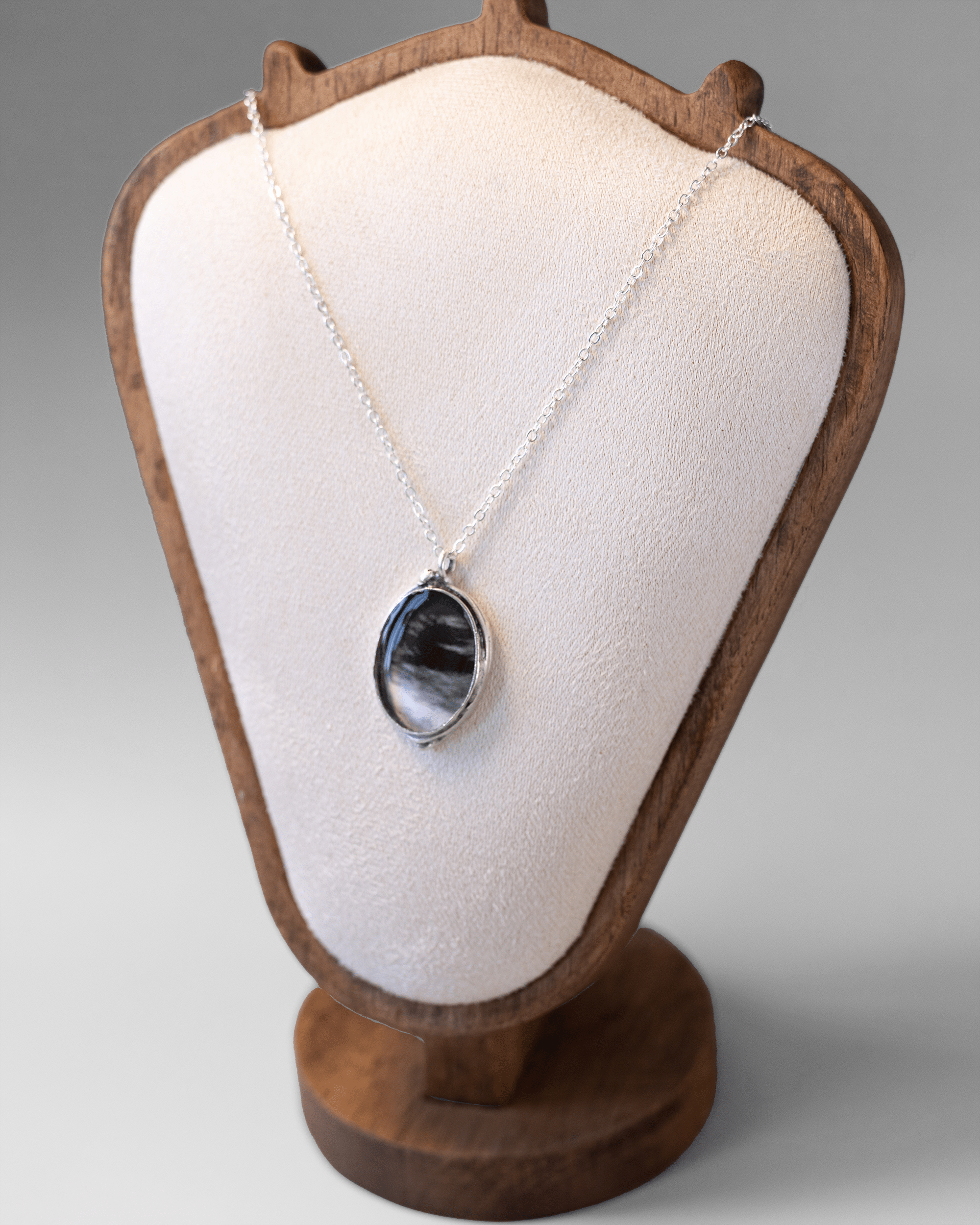 Handmade ultrasound heart necklace in resin and silver-plated brass. Anatomical science jewelry gift inspired by motion and vitality. On bust.