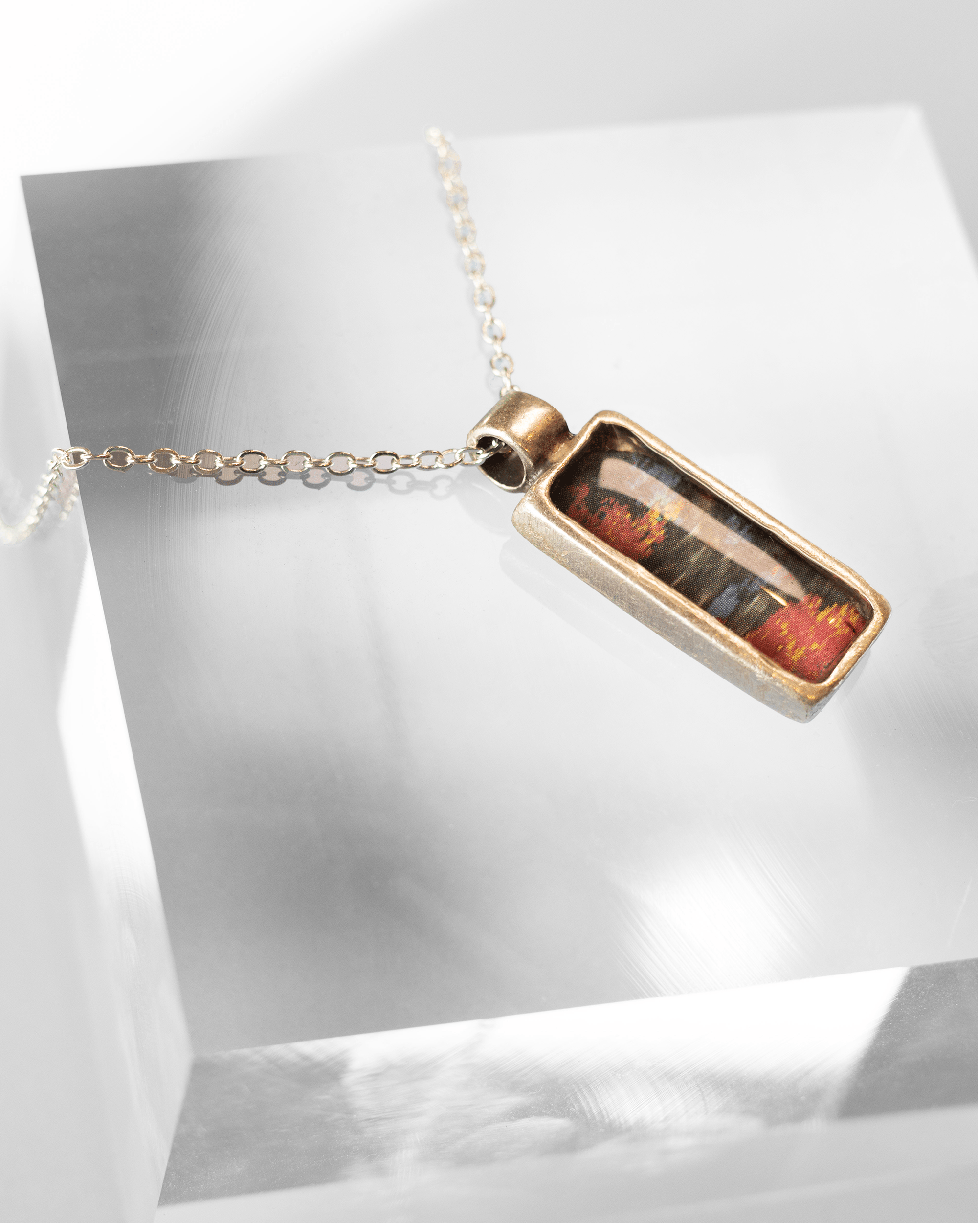Handcrafted ultrasound heart necklace in resin. Wearable anatomy-inspired science jewelry celebrating life and emotion. Side view.