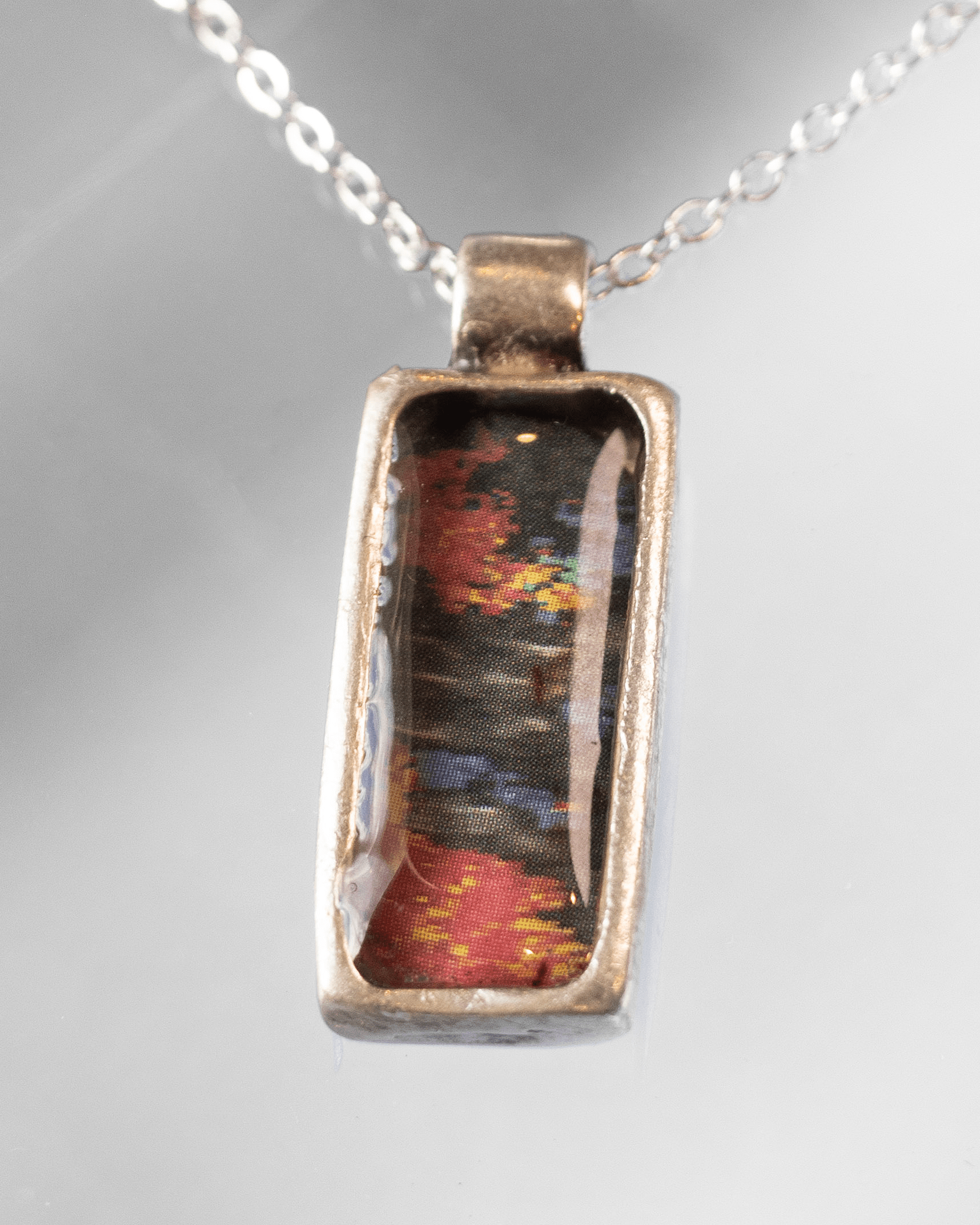 Handcrafted ultrasound heart necklace in resin. Wearable anatomy-inspired science jewelry celebrating life and emotion. Macro shot.