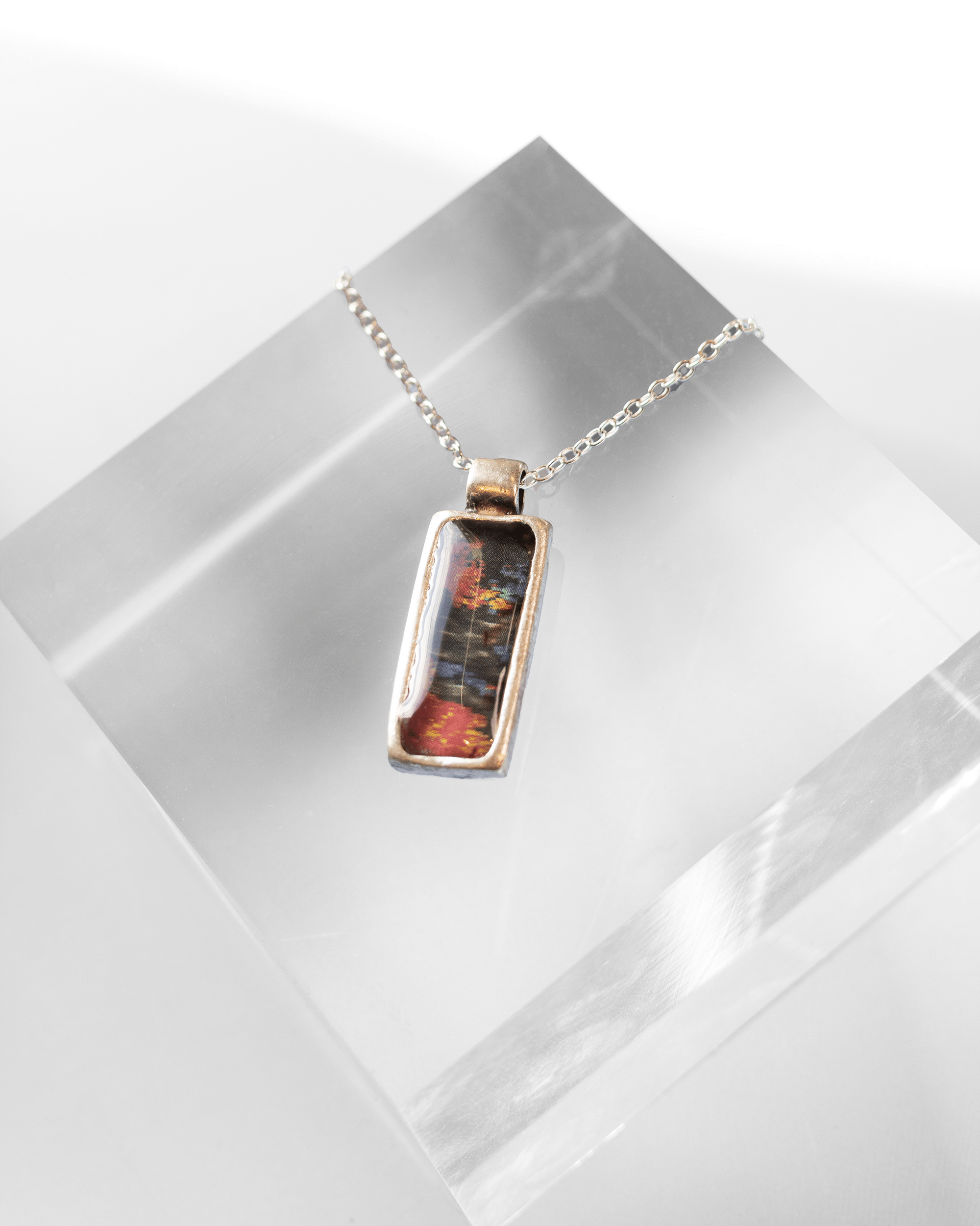 Handcrafted ultrasound heart necklace in resin. Wearable anatomy-inspired science jewelry celebrating life and emotion. Angled shot.