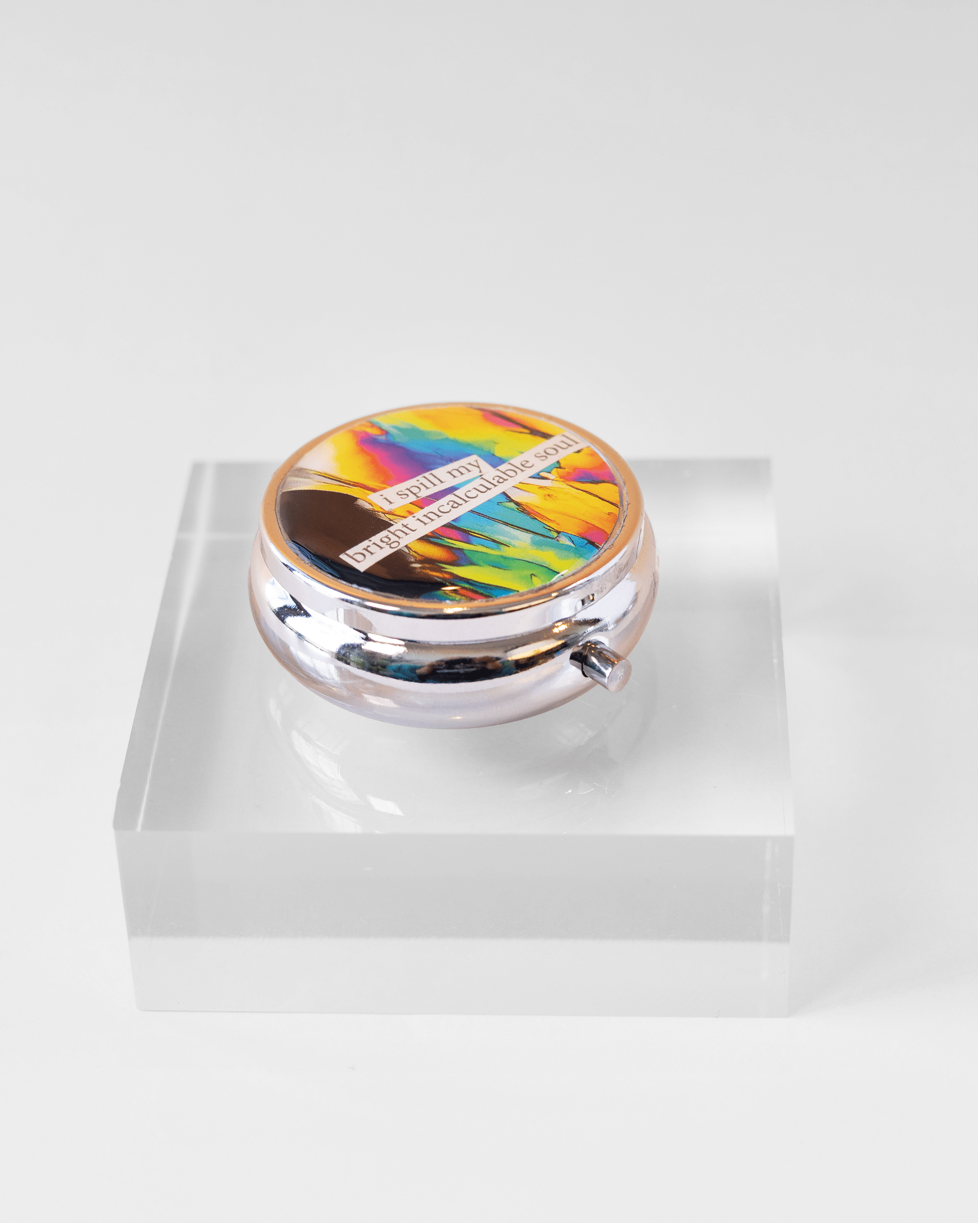 Handmade dopamine molecule pill case featuring vivid microscopy art sealed in resin. Science-inspired pillbox and meaningful STEM gift for thinkers and dreamers. Side shot.