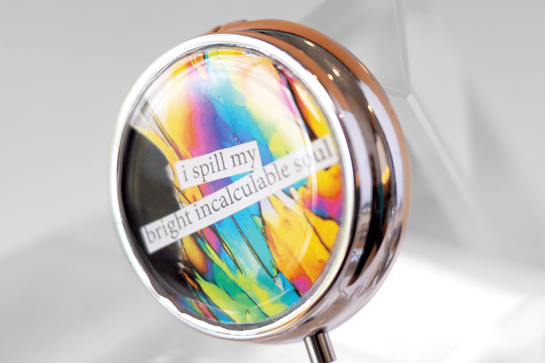 Handmade dopamine molecule pill case featuring vivid microscopy art sealed in resin. Science-inspired pillbox and meaningful STEM gift for thinkers and dreamers. Front.